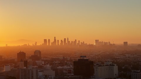 Los Angeles at sunrise. The red sun. The general plan of the city in the morning is the plan from above. Downtown Los Angeles Sunrise over the city, close-up on silhouettes of modern buildings in down