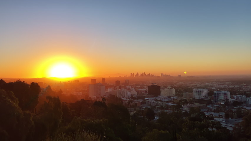 Downtown Los Angeles Sunrise over the city, close-up on silhouettes of modern buildings in downtown Los Angeles. 4K UHD
