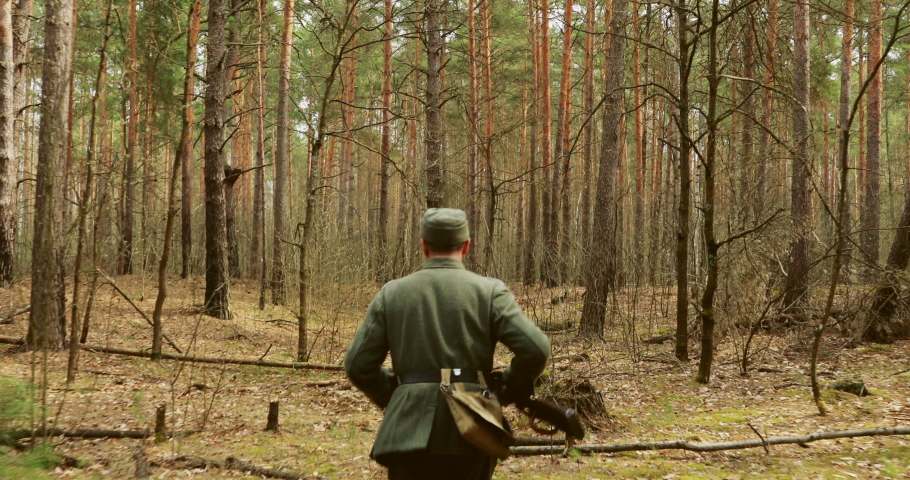 World War II German Wehrmacht Infantry Soldier Of World War II Marching Running Along Forest In Spring Autumn.