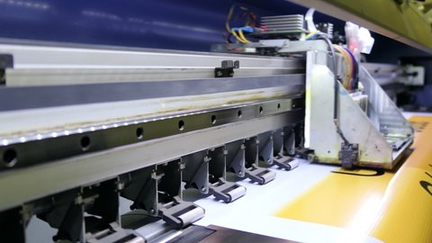 Large inkjet printer cmyk format working on vinyl in workshop