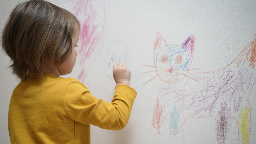 Cute adorable small kid girl artist drawing coloring picture with chalk, crayon on white wall, focused smart preschool child enjoying creative art hobby activity at home, children development concept Royalty-Free Stock Footage #1087837887