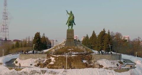 Ufa, Bashkortostan. Russia - January 20 2022: Monument to Salavat Yulaev in Ufa city center at winter sunny sunset - Aerial drone view