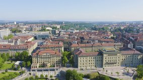 Inscription on video. Bern, Switzerland. Federal Palace - Bundeshaus, Historic city center, general view, Aare river. Arises from blue water, Aerial View, Point of interest