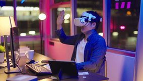 young asian man wearing virtual reality headset.Augmented Reality. Man touch something using modern 3D vr glasses indoors.business man playing using VR glasses to meeting online.Shot on 4K - Powered by Shutterstock - Get 15% off with code: PIKWIZARD15