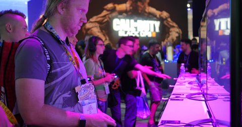 LOS ANGELES - June 16, 2015: Gamer playing video games at E3 2015 expo in Convention Center. Electronic Entertainment Expo, commonly known as E3, is an annual trade fair for the video game industry.