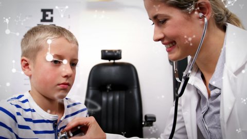 Animation of molecules over smiling caucasian female doctor examining boy. global medicine, science and healthcare services concept digitally generated video.