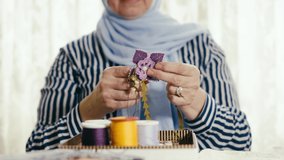 woman doing needlework. traditional Turkish handicrafts. slow motion. 4K. Traditional handicraft hobby.