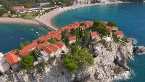 Aerial shot. Slowmotion video of the Sveti Stefan island. Famous tourist location near the city of Budva. Travel to Montenegro concept
