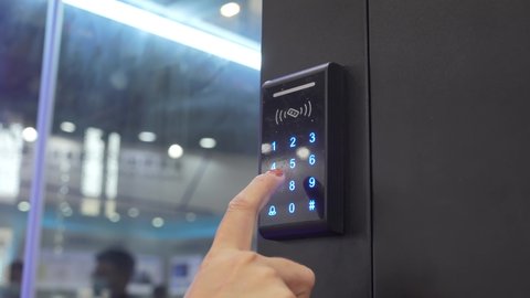 Woman push down electronic control machine with finger scan to access the door of or data center. The concept of data security or data access control.