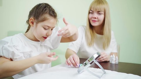 a doctor teaches girl to put on contact lenses in the clinic. Advertising contact lenses for vision. Ophthalmology, optical store, health care and medicine. orthokeratological lenses