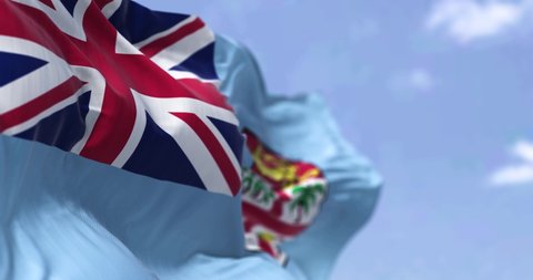 Detail of the national flag of FIji waving in the wind on a clear day. Fiji is an island country in Melanesia, part of Oceania in the South Pacific Ocean. Selective focus. Seamless slow motion