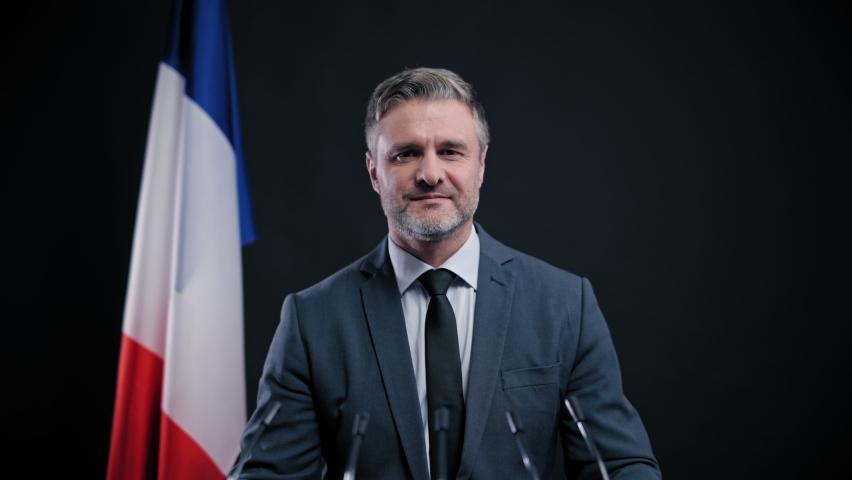 Confident French politician making election promises to voters looking at camera
