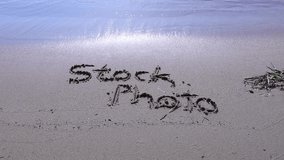 Stock photo sign letters on the beach wave