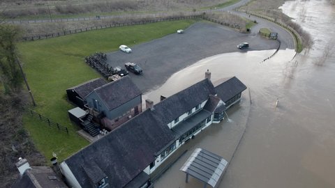 River Severn busts its banks and floods pub water pumped out drone view UK