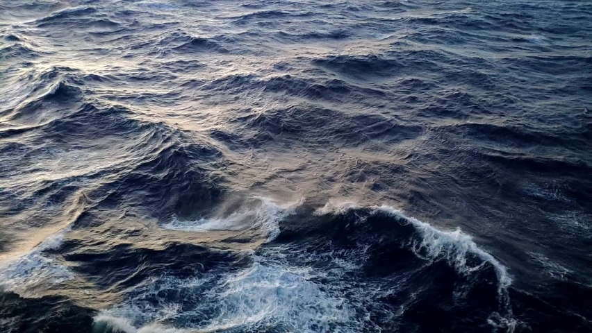 View of agitated water in open sea. There is fairly strong tide and water moves clearly. Nice light from sunset hour. Royalty-Free Stock Footage #1087863123