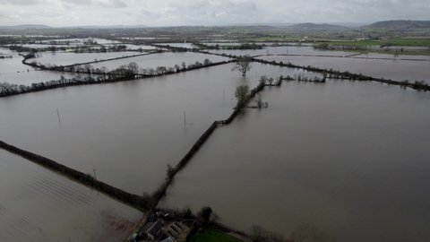 Flooded farm fields after storm in England aerial panning shot 4K