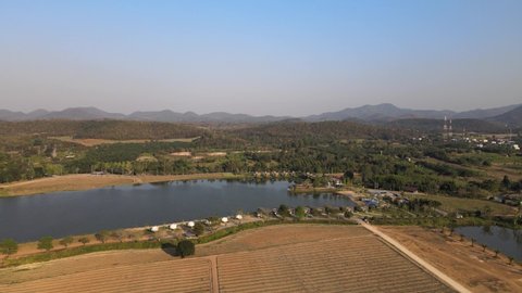 Aerial Footage with Orbital Pan of a Lake and Resort in Thailand with Beautiful Scenery.