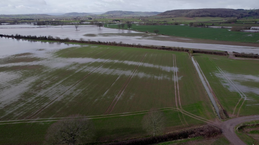 Huge areas of farmland flooded with rain water UK aerial drone panning shot Royalty-Free Stock Footage #1087864479