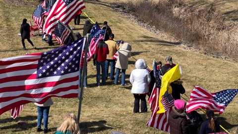 DAYTON, OHIO - MARCH 3: People along I-70 highway waiting for convoy of trucks head to Washington DC in Dayton, Ohio on March 3, 2022.