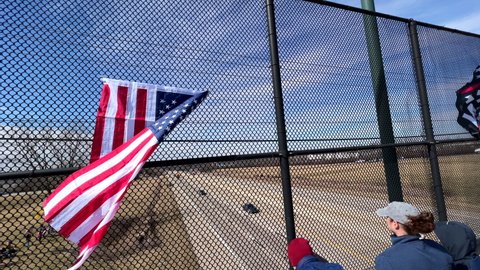 DAYTON, OHIO - MARCH 3: Flag hanging on overpass where supporters of convoy heading to Nation's Capitol of Washington DC gather in Dayton, Ohio on March 3, 2022.
