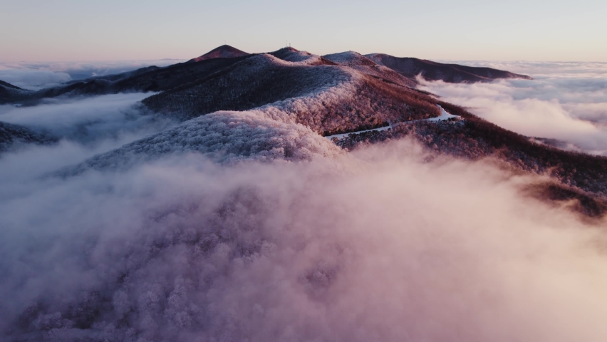 Sunrise drone footage of frosted trees high up in the Appalachian mountains of North Carolina. Royalty-Free Stock Footage #1087867437