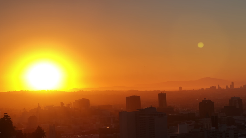 The red sun. The general plan of the city in the morning is the plan from above. Downtown Los Angeles Sunrise over the city, close-up on silhouettes of modern buildings in downtown Los Angeles. 4K UHD