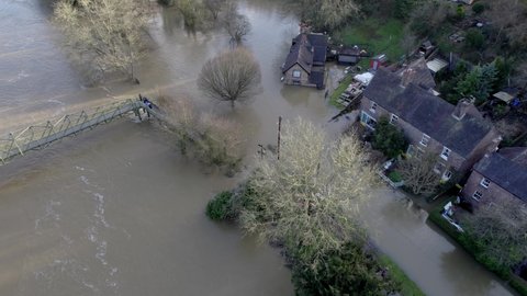 River Seven bursting its banks and flooding row of houses at Ironbridge UK drone view