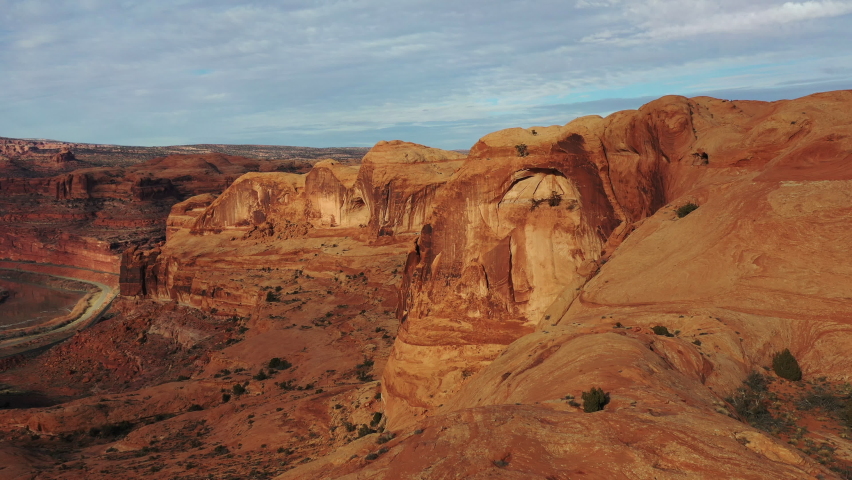 Beautiful red cliffs towering over the Colorado River in Grand Canyon National Park, Arizona, USA. Panning aerial 