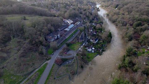 Houses in danger of being flooded Ironbridge gorge England Uk done view