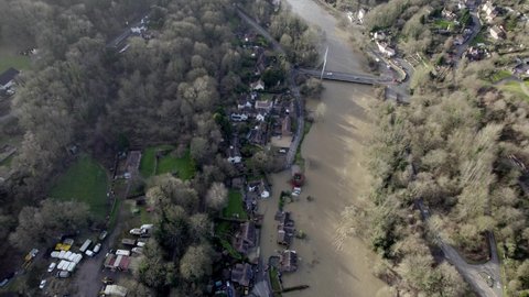 Flooded fields and houses river Severn in Ironbridge England high drone aerial view