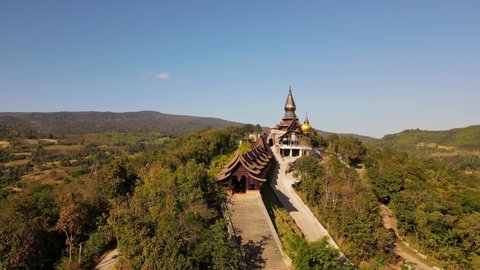 Aerial footage towards the famous Wat Somdet in Phu Ruea as it ends above the roof, Ming Mueang, Loei in Thailand.