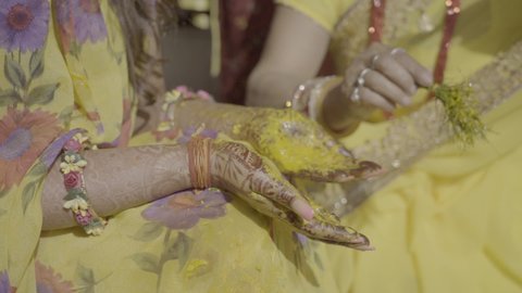  Turmeric is being applied in the hands of the bride in India called as Haldi Ceremony. An Indian wedding tradition.