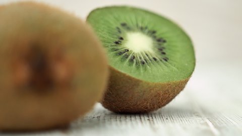Sliced in half Kiwi fruit against a white rustic background HD 