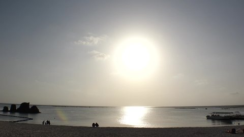 CHATAN-CHO, OKINAWA, JAPAN - AUG 2021 : View of Araha beach (Ocean or sea) in sunset time. Wide view, long time lapse shot, dusk to night. Summer holiday, vacation and resort concept shot.