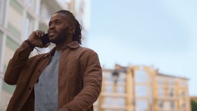 Casual man making phone call walk city street portrait. Urban lifestyle concept. Confident attractive african american man texting talking use smartphone. Focused young boy going to friend meeting - Powered by Shutterstock - Get 15% off with code: PIKWIZARD15