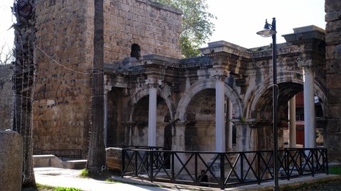 walk through the old city in Antalya. winter season. Hadrian's Gate is an iconic location in Antalya, a popular tourist place
