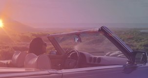 Animation of happy biracial woman wearing glasses, driving a cabriolet at sunset. travel, holidays and freedom concept digitally generated video.