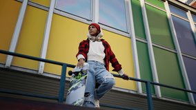 Young multiracial woman outdoors in the city, with skateboard looking at camera. - Powered by Shutterstock - Get 15% off with code: PIKWIZARD15