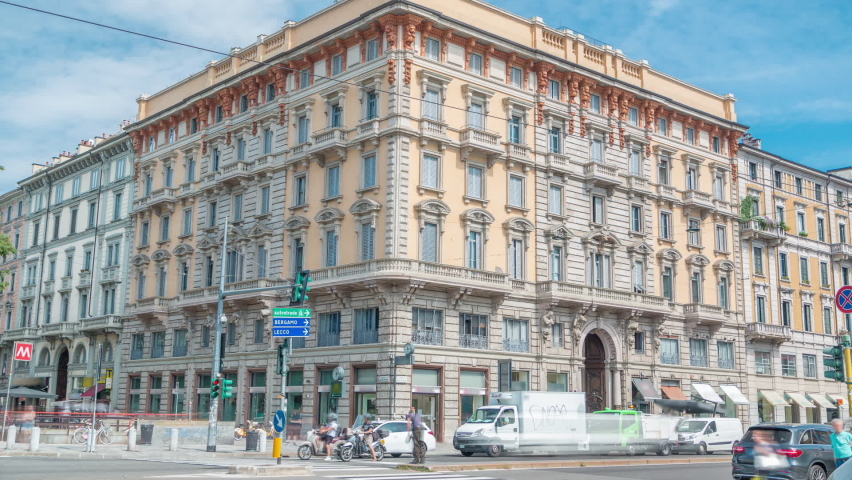 Palazzo Luraschi near Porta Venezia timelapse (crossroad on Avenue Buenos Aires and street Bastioni di Porta Venezia). Milan, Italy. Traffic on the road. Blue sky at summer day