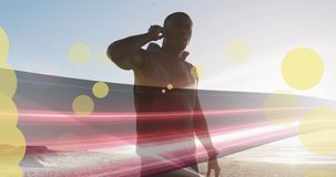 Animation of spots over african american man with earphones at beach. health and fitness concept digitally generated video.