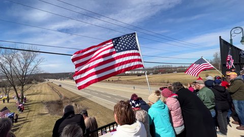DAYTON, OHIO - MARCH 3: American Flag waving while people wait for DC Truck Convoy in Dayton, Ohio on March 3, 2022.