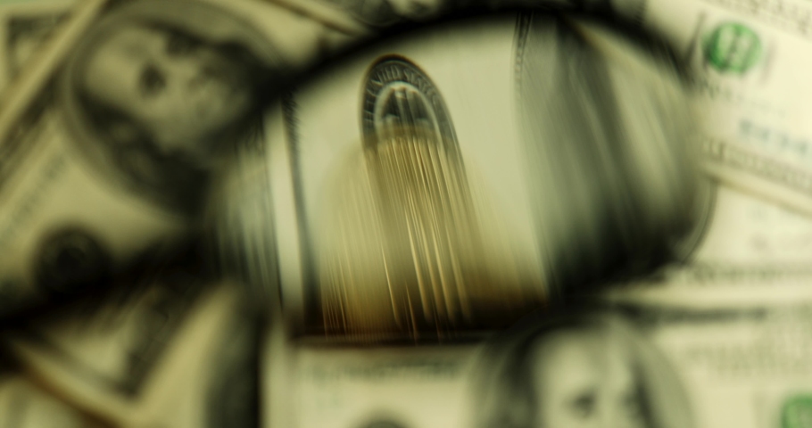 Magnifying glass, bitcoins in dollars. High quality photo