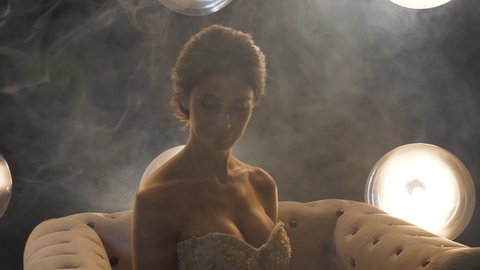 Fiancee with festive look poses in smoke for photoshoot