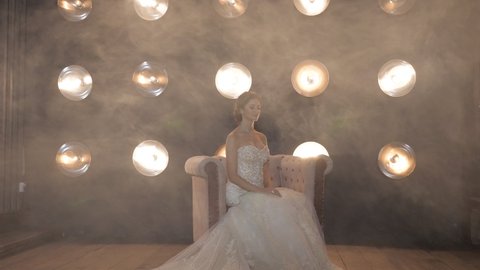 Backlight lamps illuminate smoke covering fiancee in studio