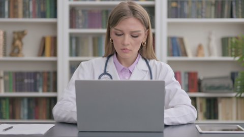 Lady Doctor Working on Laptop in Clinic