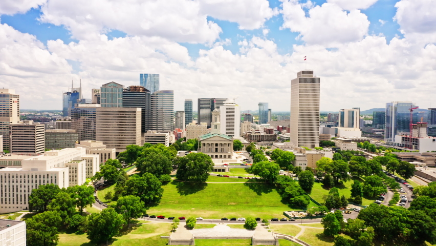 Aerial view of Nashville skyline with a slow forward camera motion towards the State Capitol. Nashville is the capital and most populous city of Tennessee, and a major center for the music industry