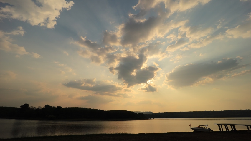 Time-lapse photography of evening sky, red, orange, yellow clouds over the river