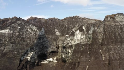 Massive Rock Mountains With Caves Near Katla Volcano In Southern Iceland. Aerial Shot