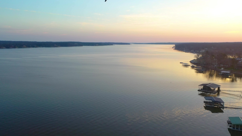 Bird Flying Across Calm Waters Of Grand Lake O