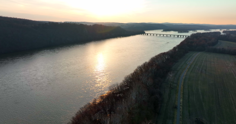 River trail through woodland. Winter aerial scene at sunset. Susquehanna River in Lancaster and York County Pennsylvania, USA.